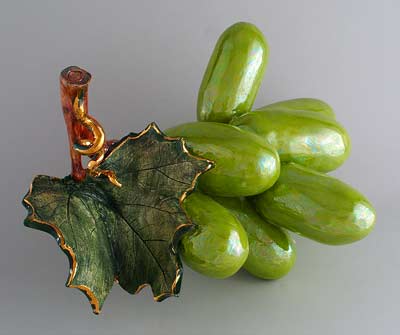 Green grapes highlighting leaf, gold trim